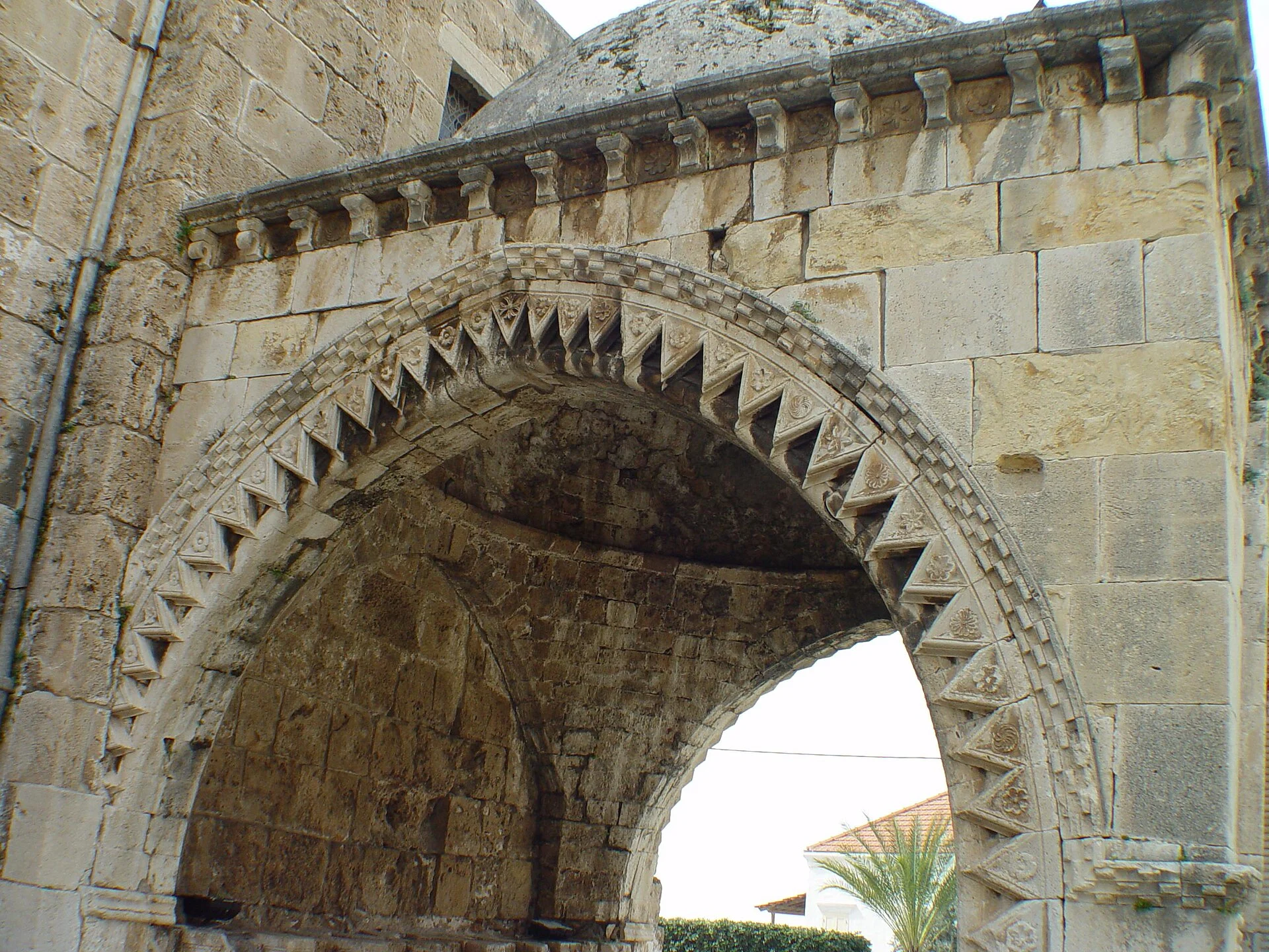 The pointed arch of the baptistery, carved with a band of zigzag ornament