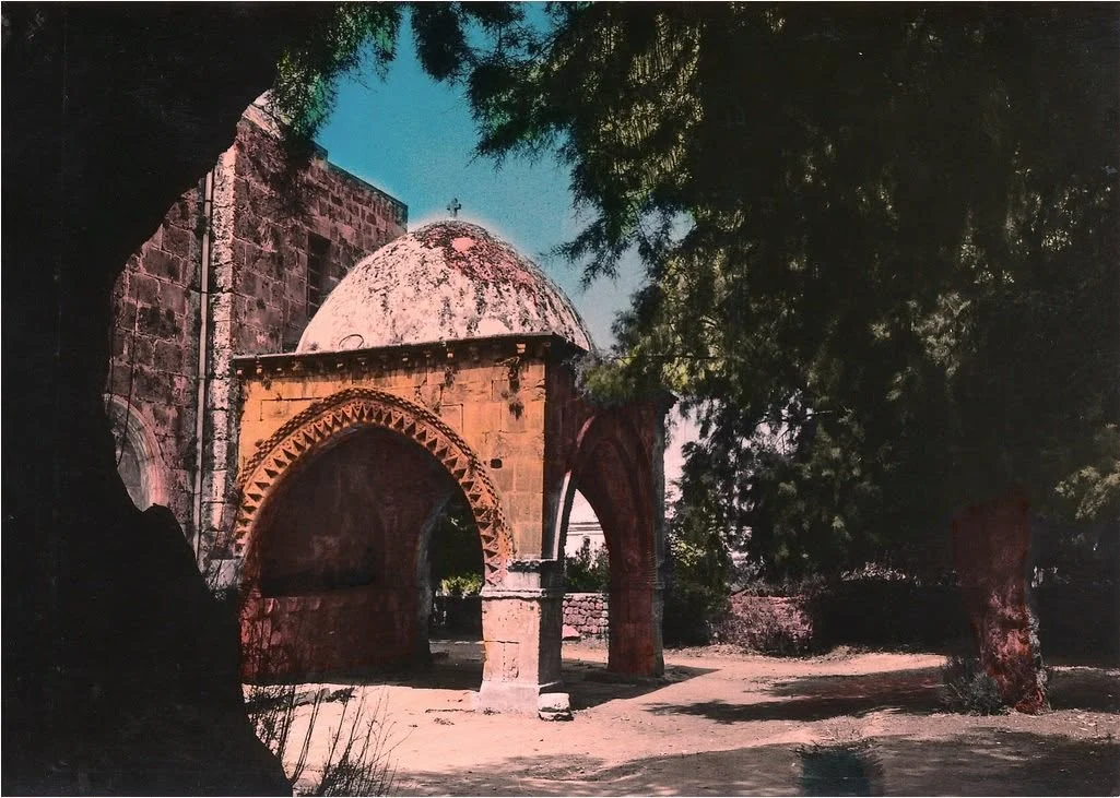 A hand-coloured postcard of the baptistery: the domed porch on its carved pointed arches, under trees