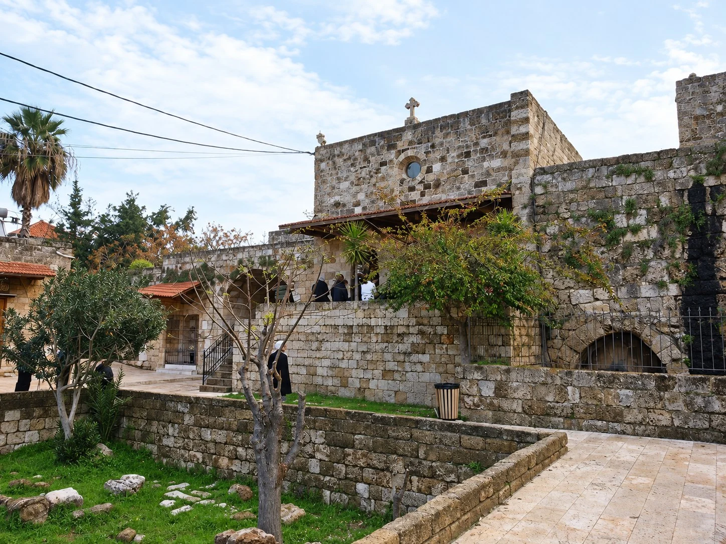 Our Lady of the Gate above its garden of olive trees and old stones, inside the walls of the city